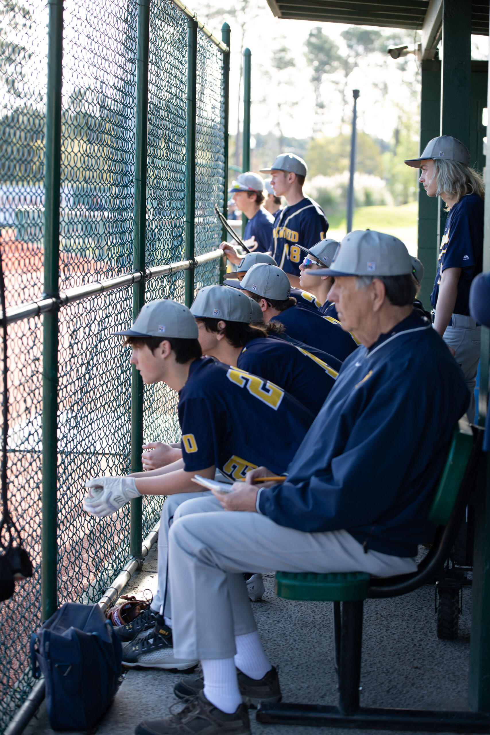 Baseball players sitting in dugout