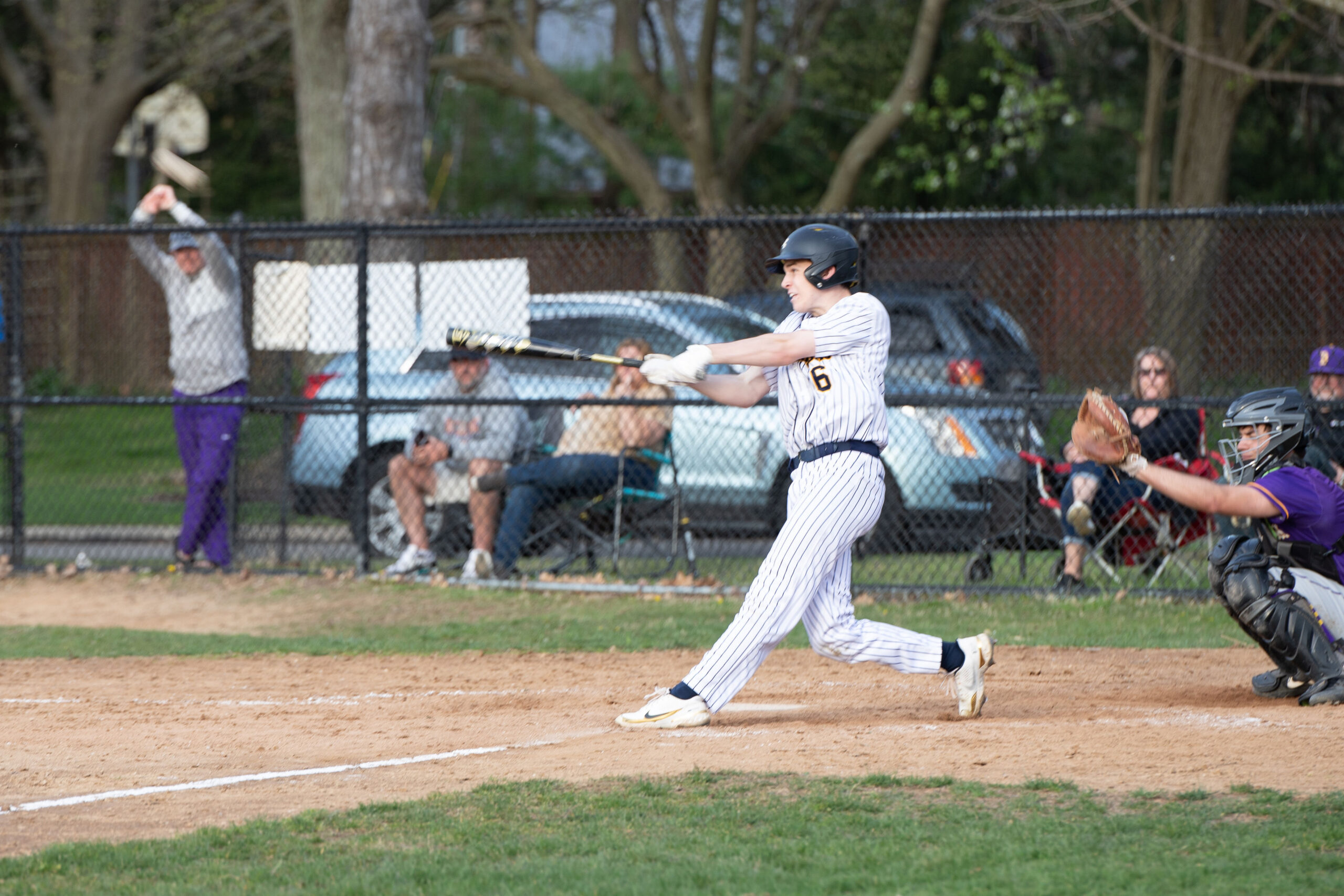 baseball player swinging to hit a pitch